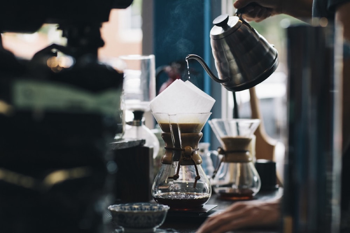 Pour-over coffee brewing into a glass carafe