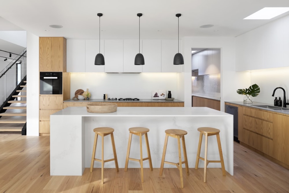 A bright modern kitchen with a marble island