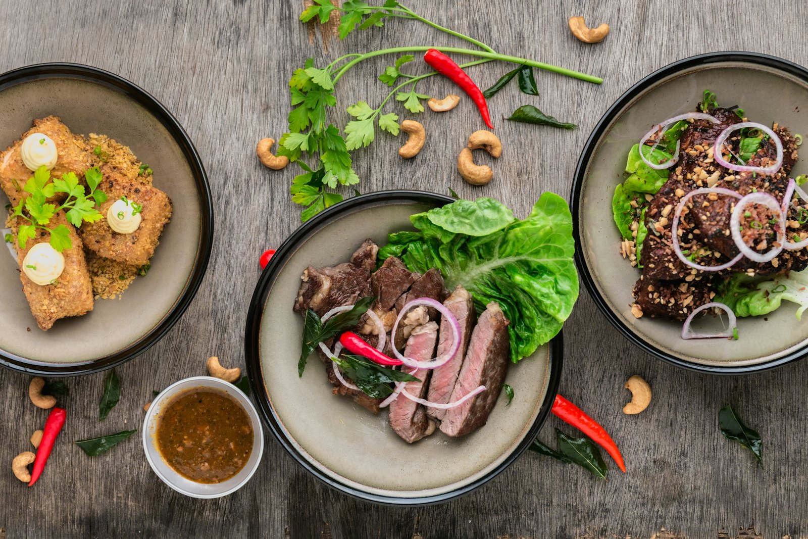 Seared steak and sides plated on a wooden board