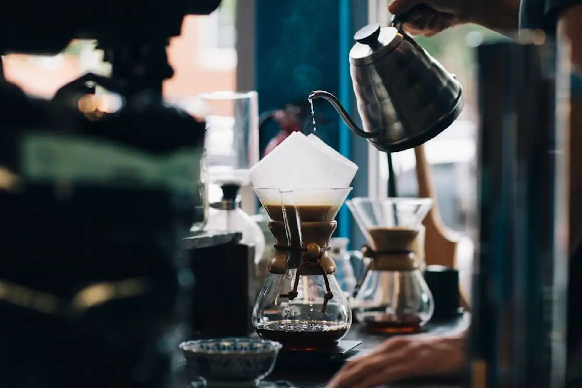 Pour-over coffee brewing into a glass carafe
