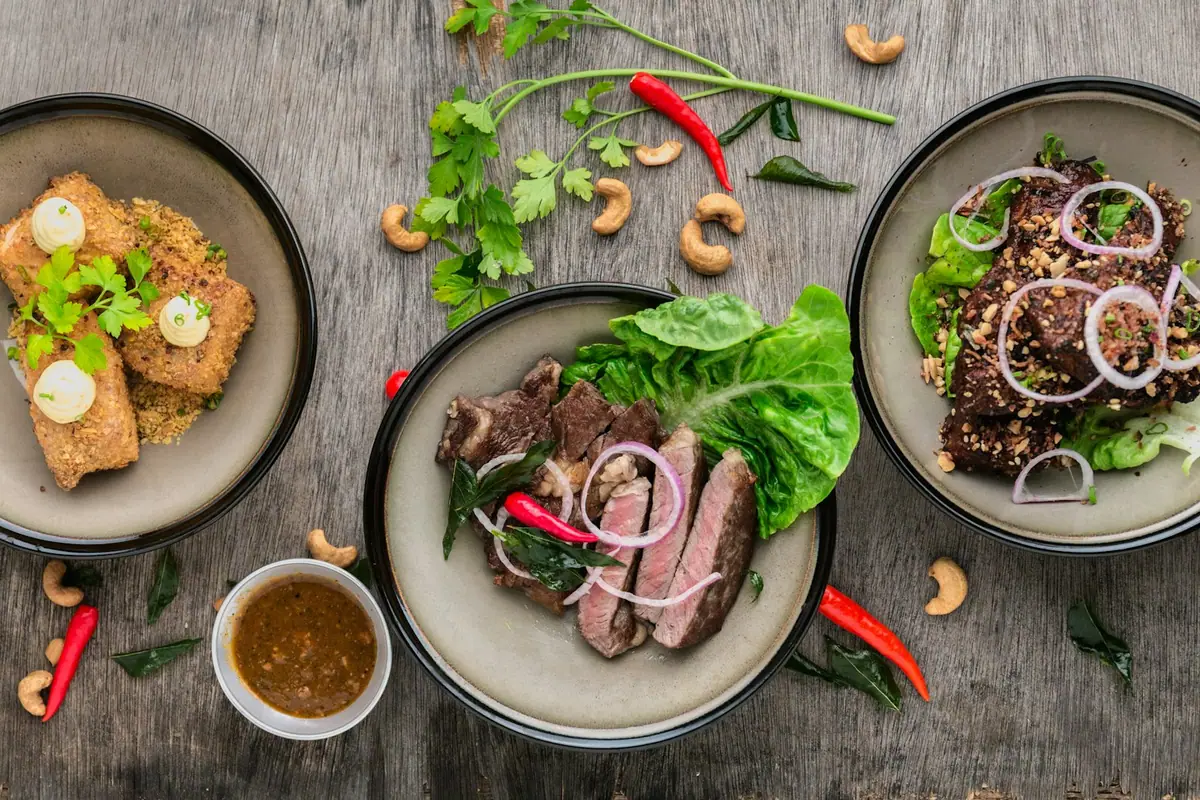 Seared steak and sides plated on a wooden board