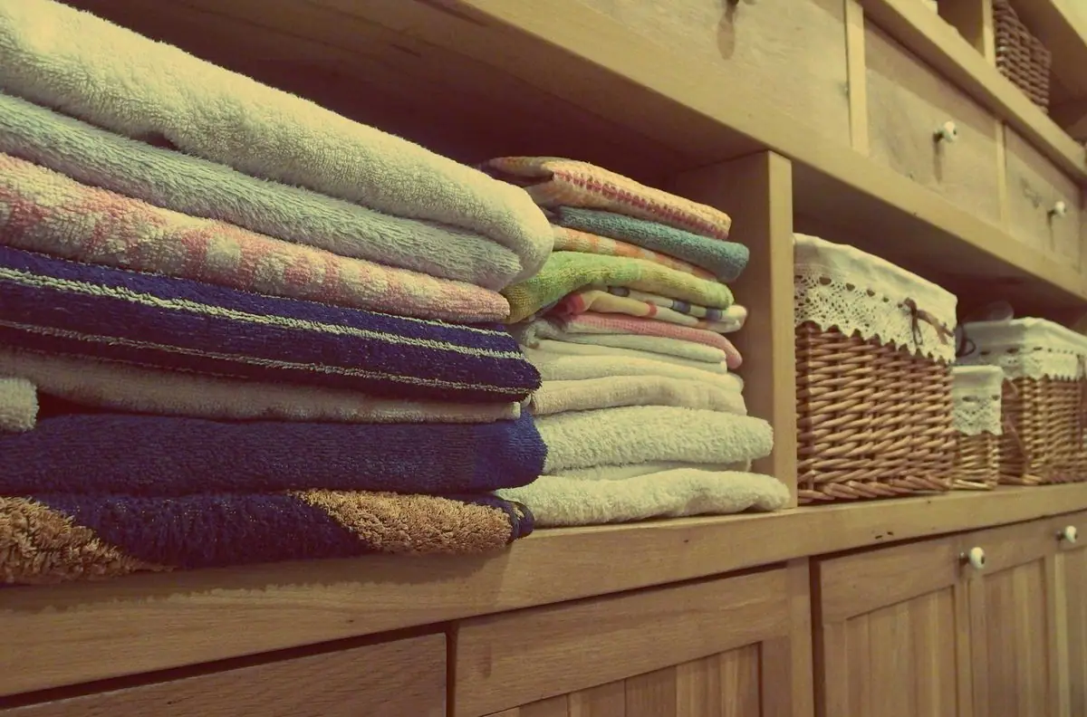 A stack of folded towels on a rack