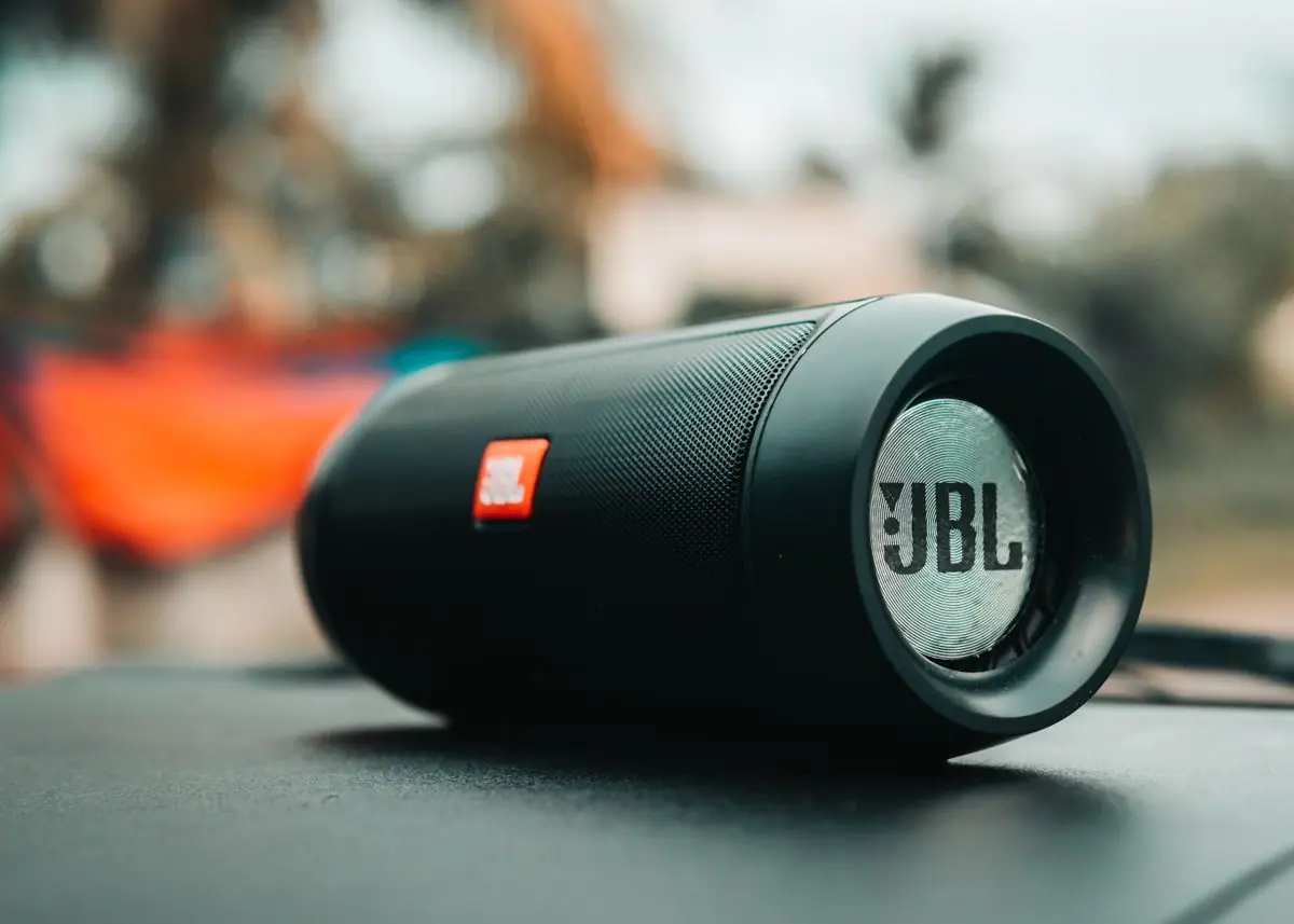 A black portable Bluetooth speaker on a surface