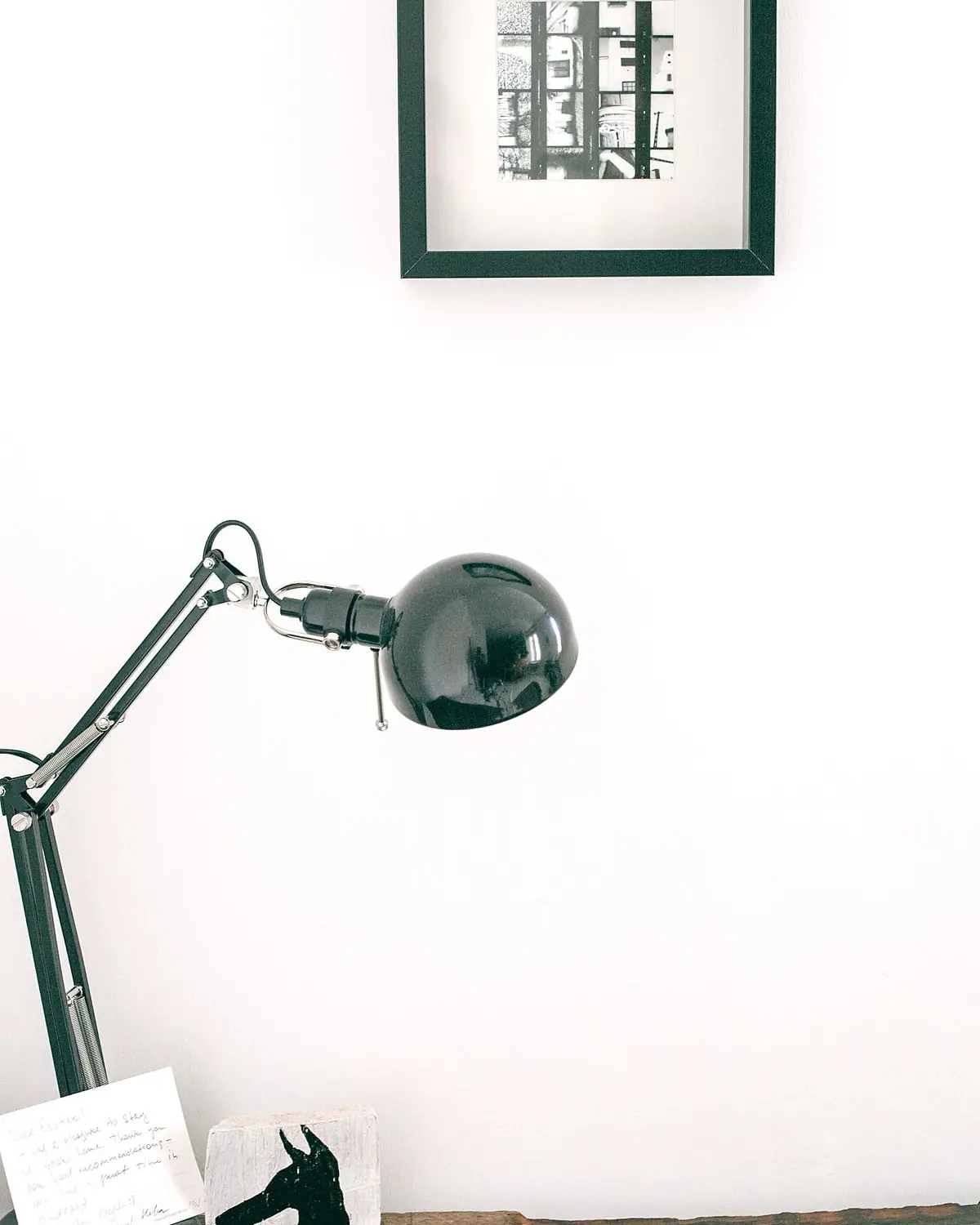 A modern black desk lamp on a wooden table