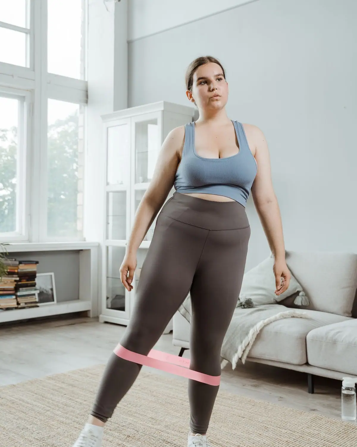 A woman exercising with a resistance band