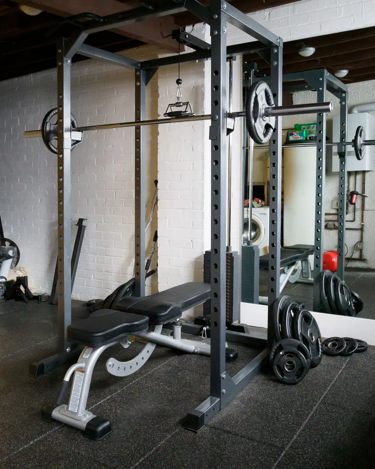 A home gym with a weight bench and barbell