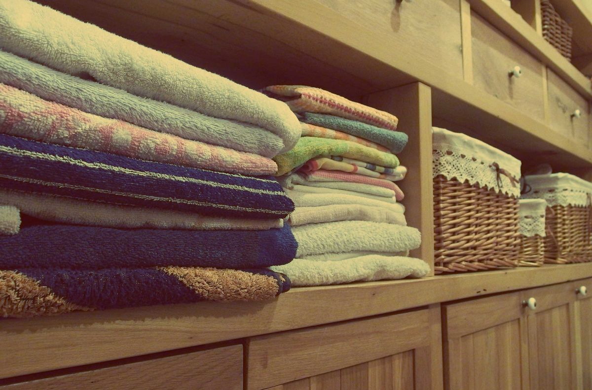 A stack of folded towels on a rack