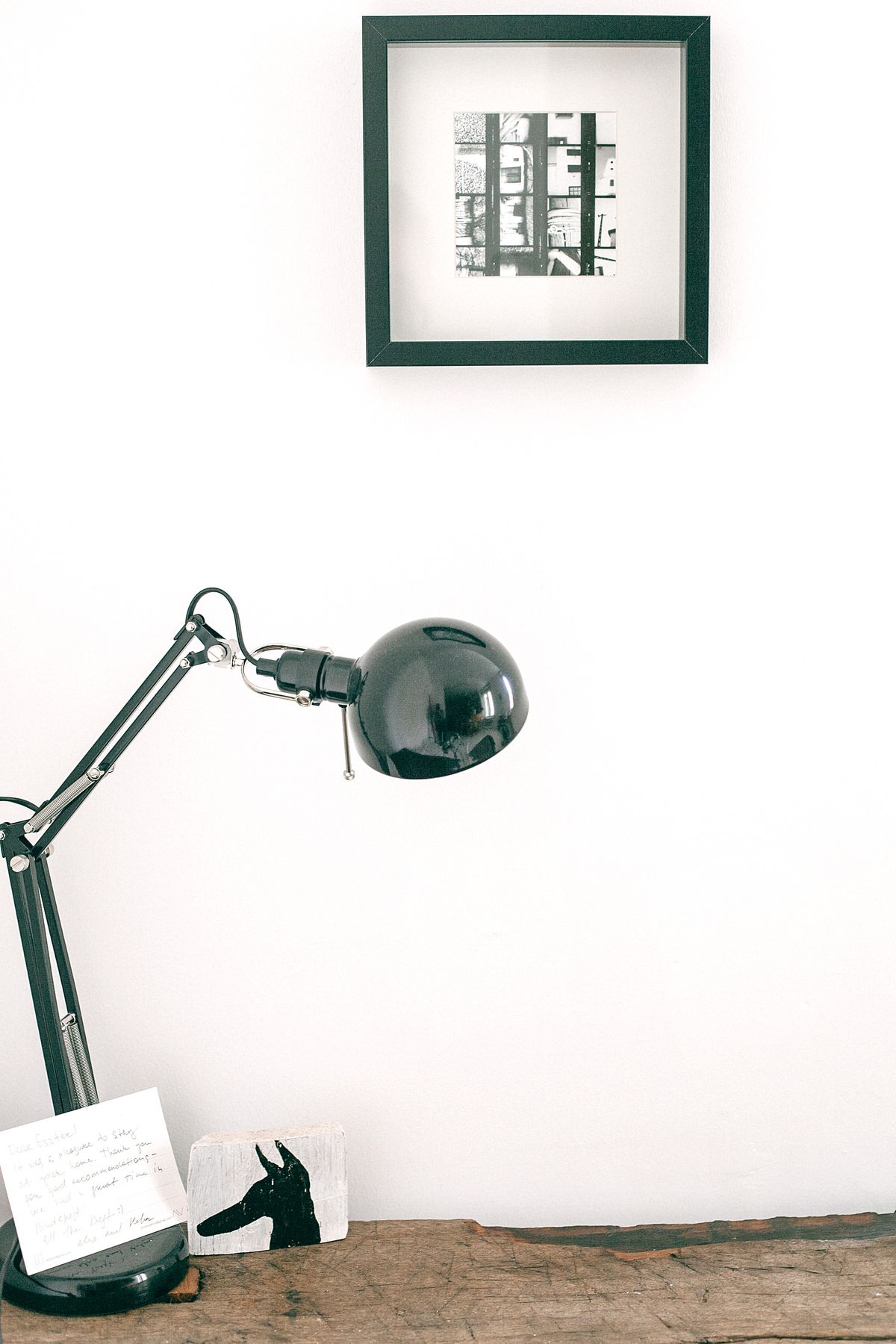 A modern black desk lamp on a wooden table