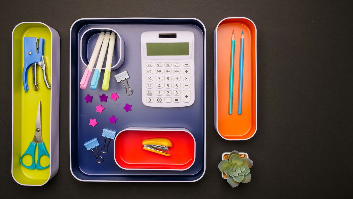Desk accessories and pens organized in trays