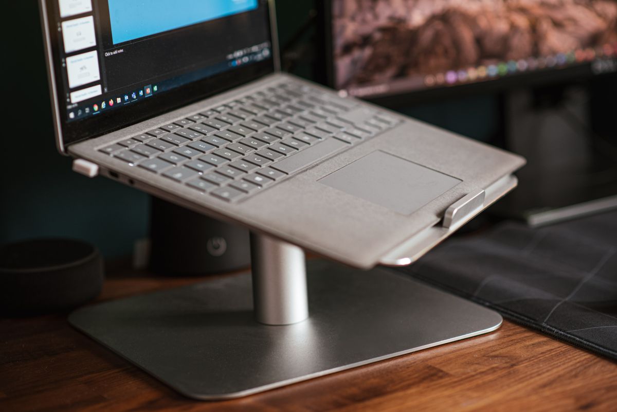 A laptop on a stand on a desk
