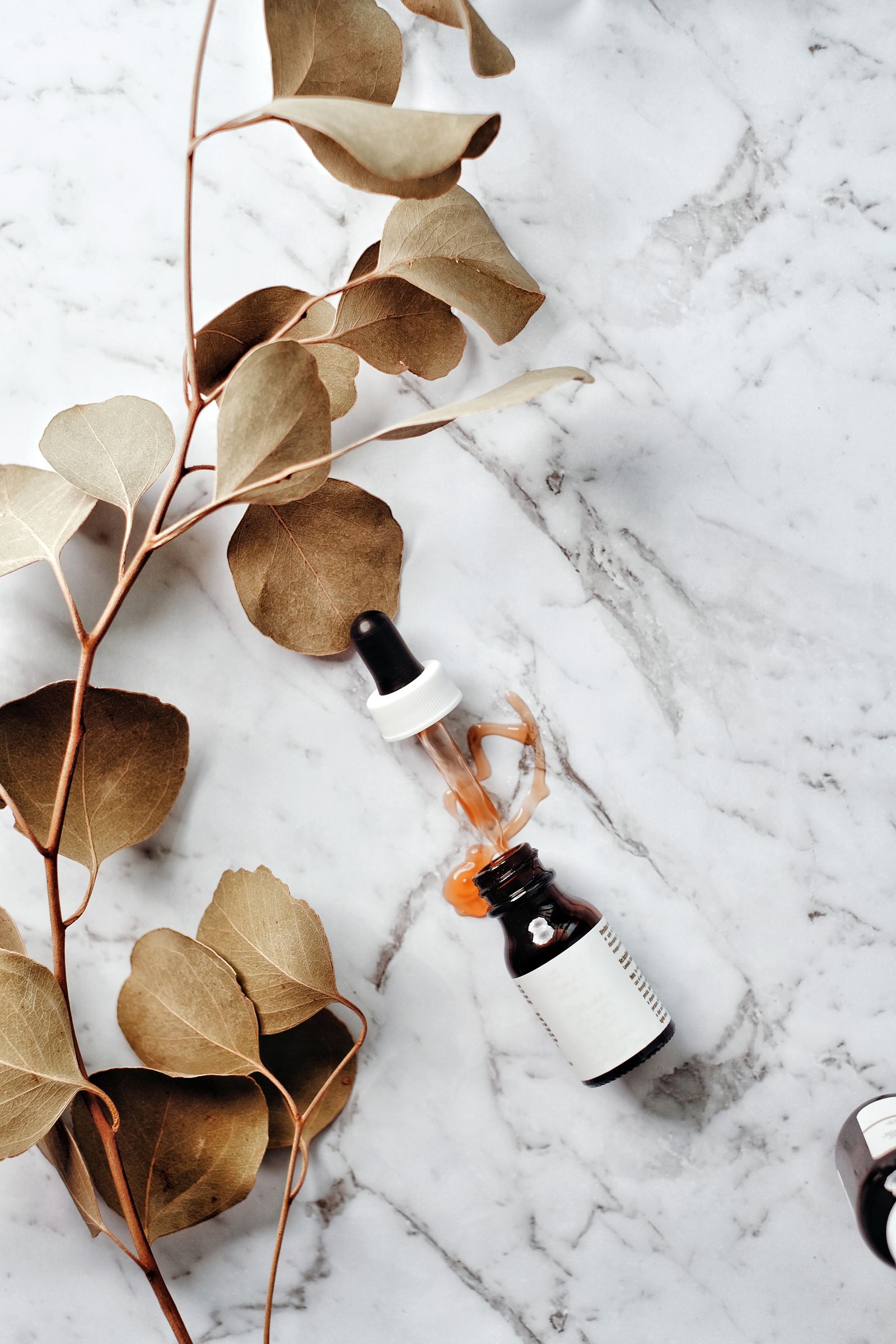 A luxury skincare serum glass bottle and pipette dropper