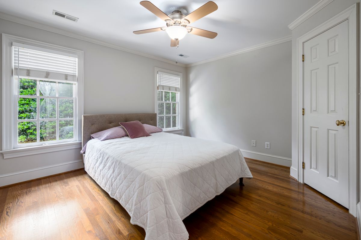 A bed with crisp white linen in a bedroom