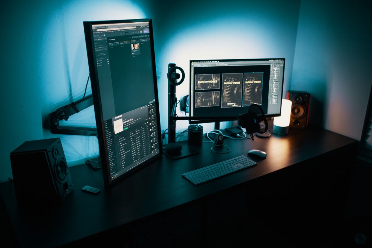 A desk with a dual monitor setup