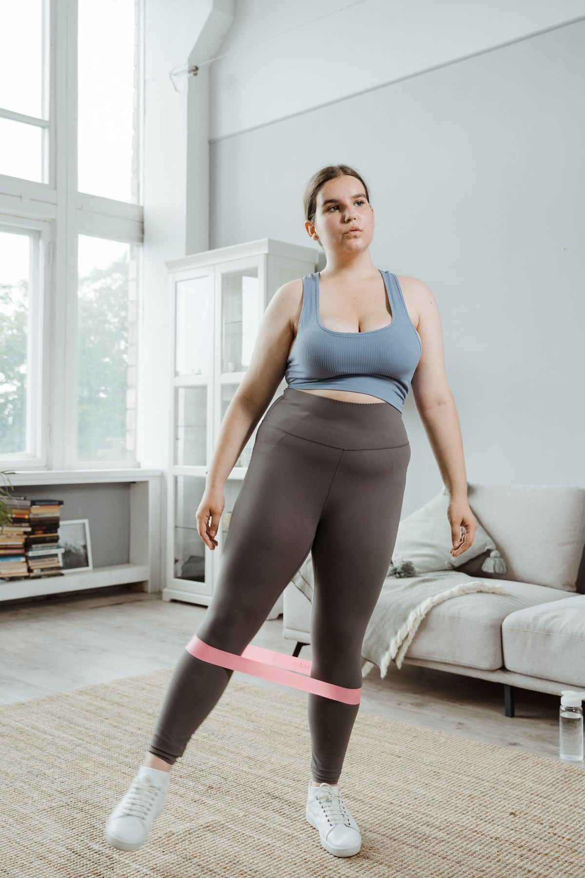 A woman exercising with a resistance band