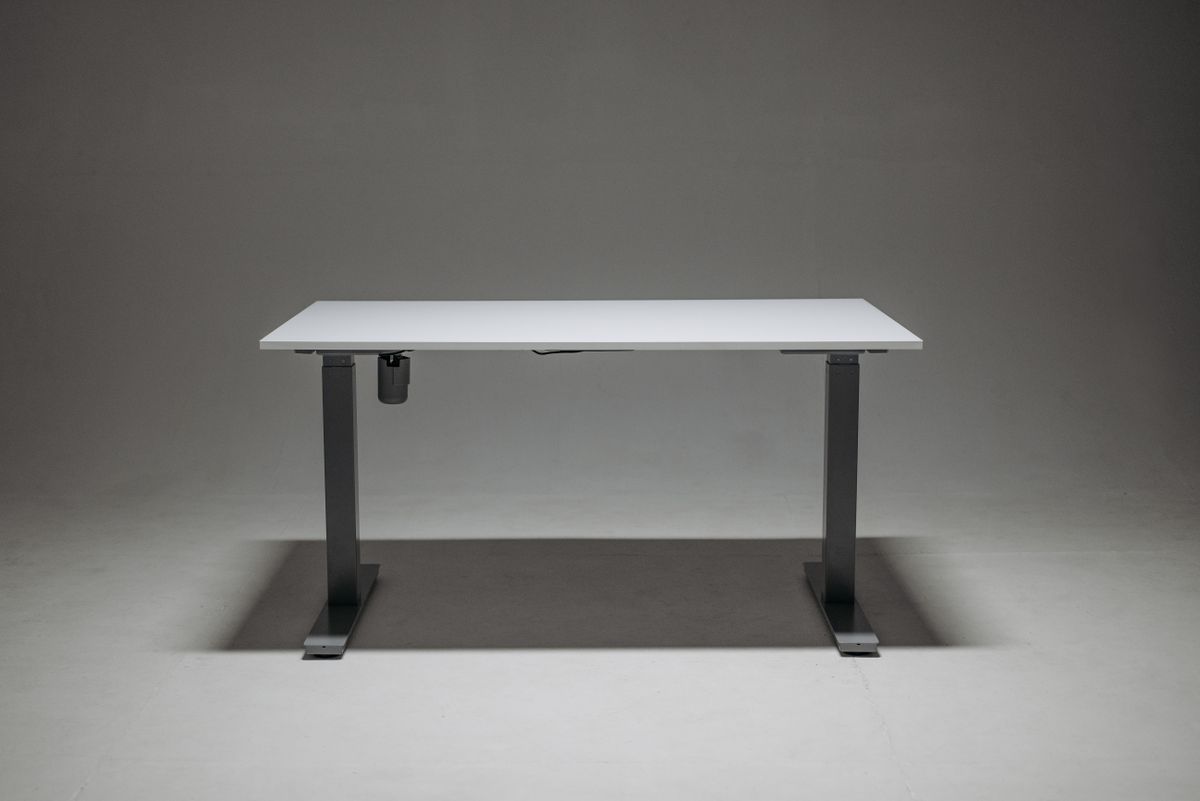 A white height-adjustable standing desk