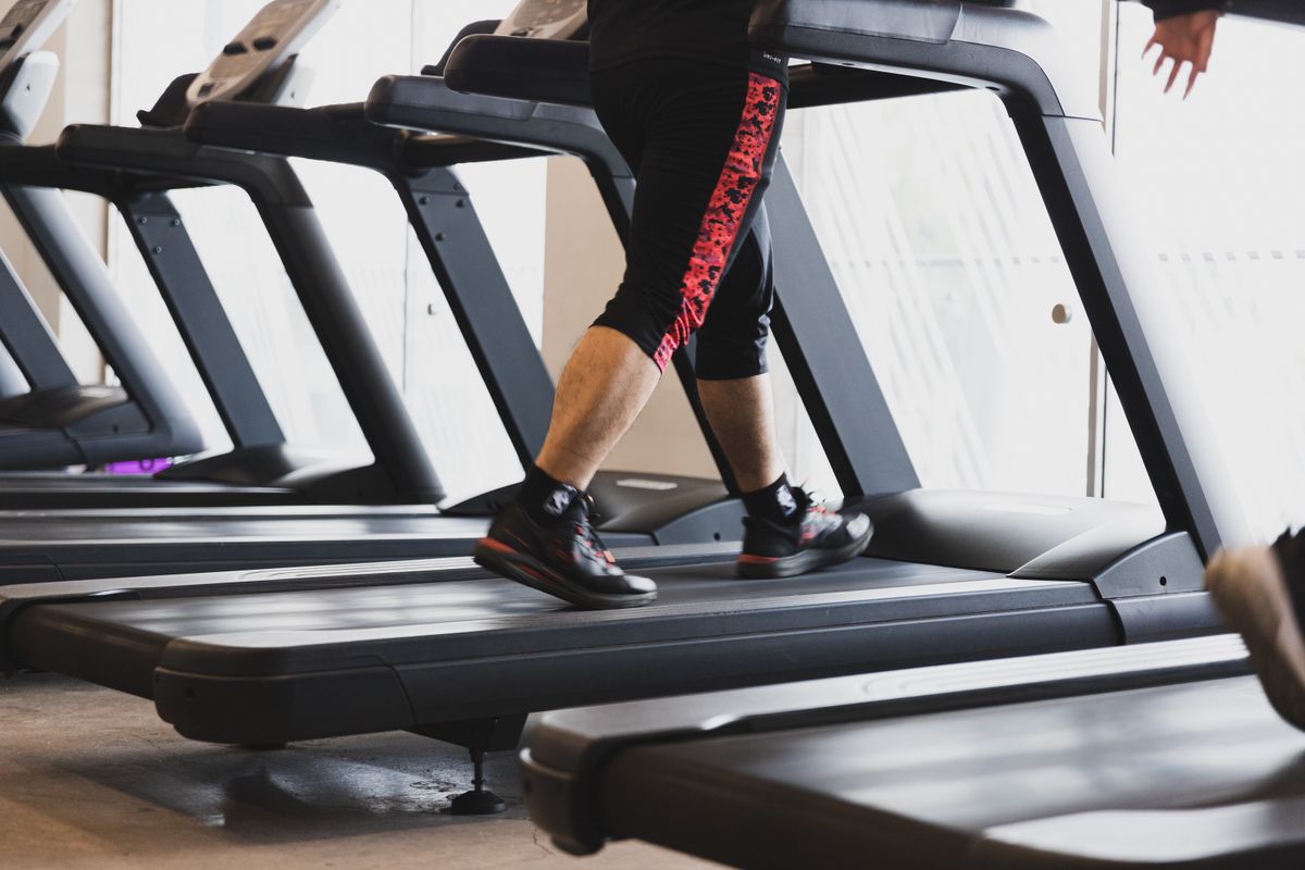 A person walking on a treadmill in a gym