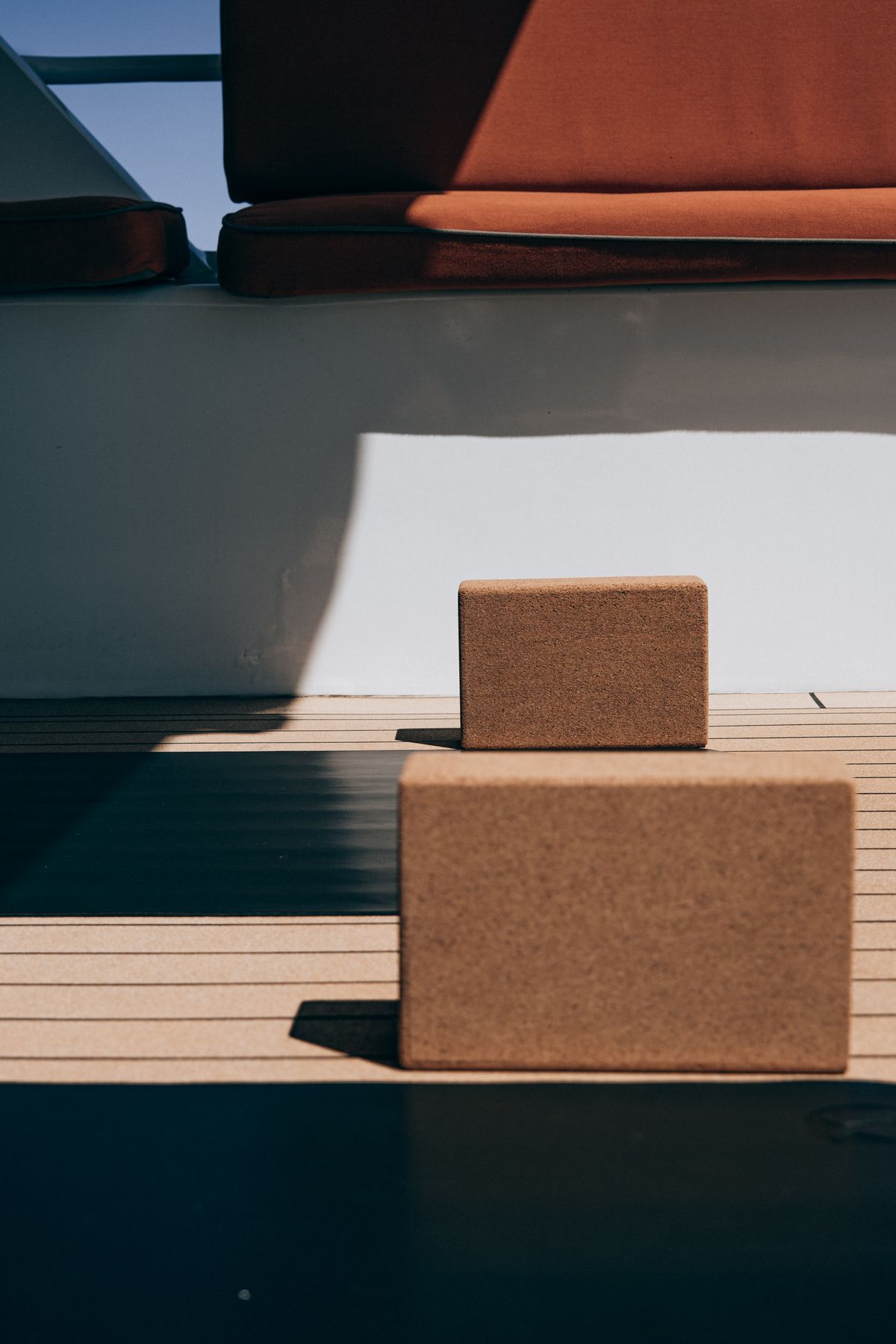 Yoga mats and cork blocks laid out on a wooden floor