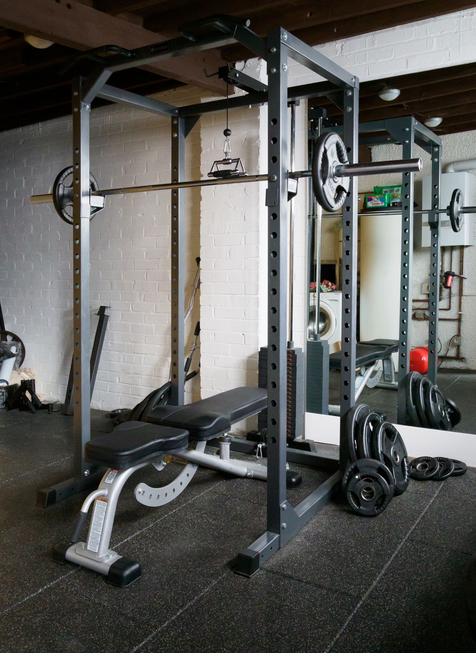 A home gym with a weight bench and barbell